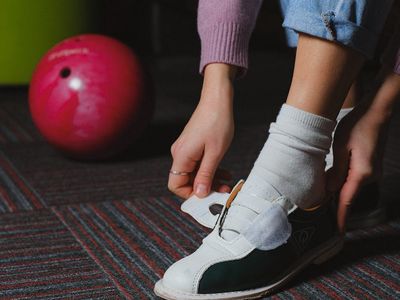 Focus on sports shoes on a dark wooden floor